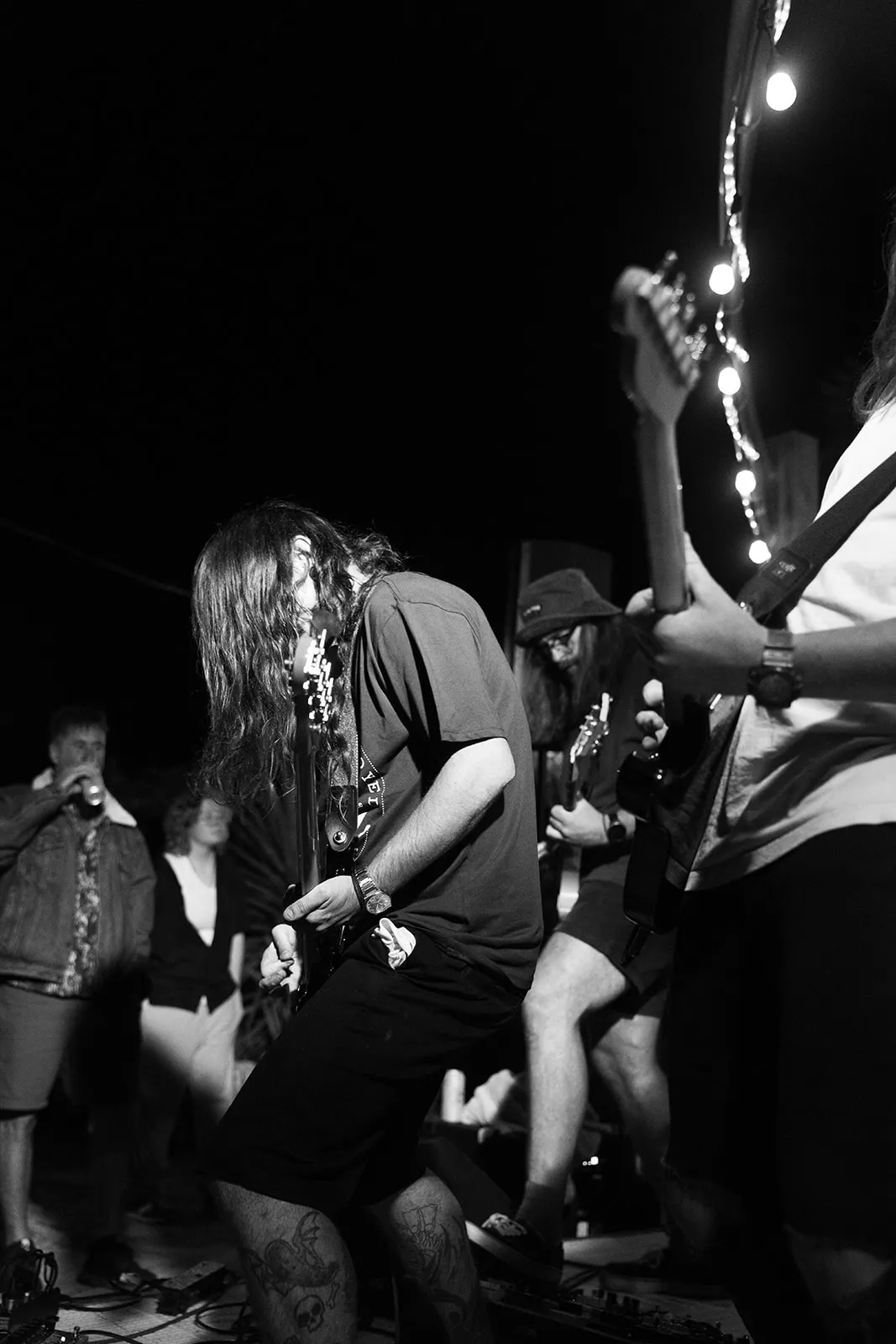 Energetic black and white moment between band members on stage