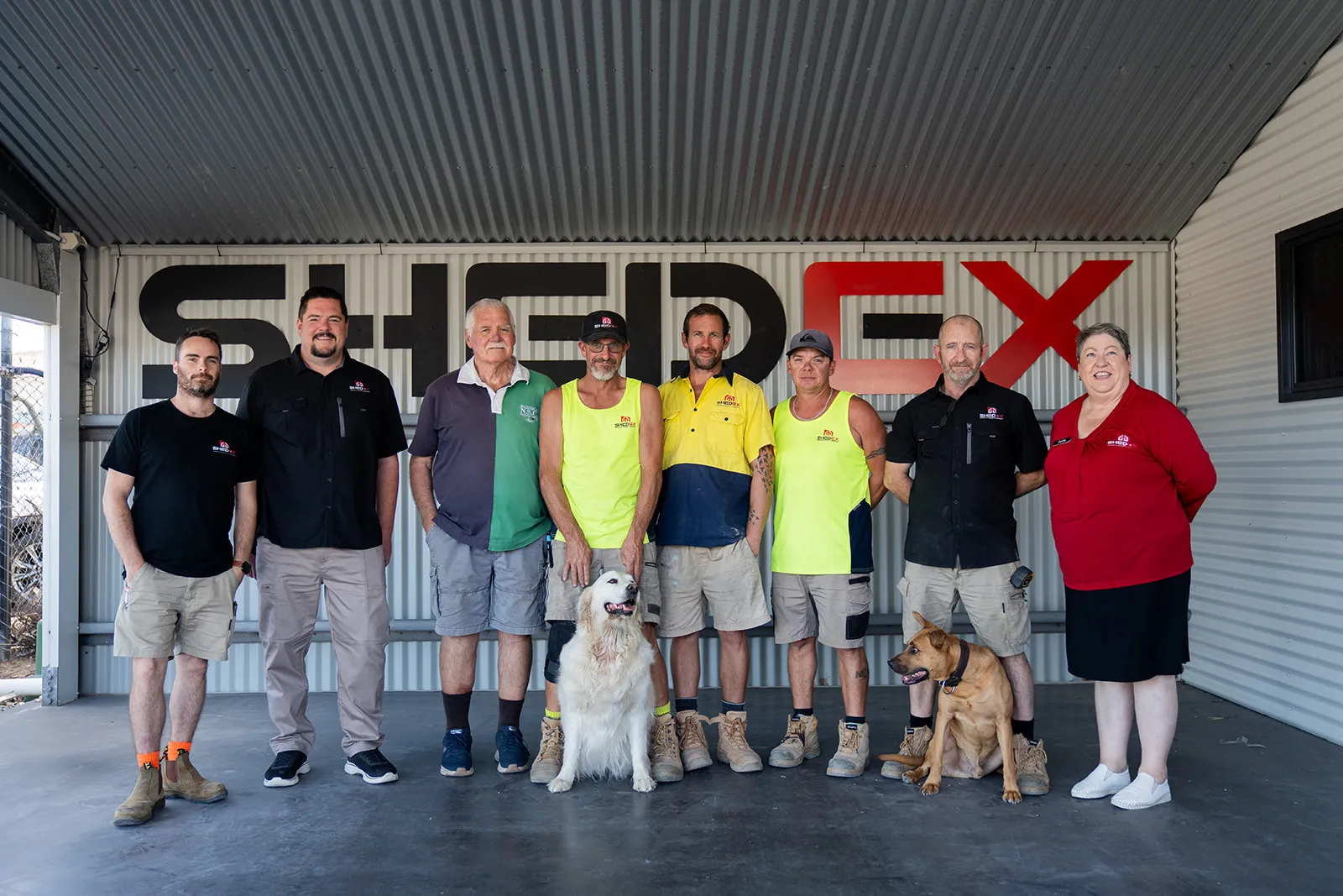 The full company team in front of the workshop