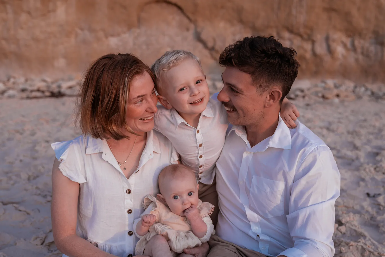 Warm, expressive family cuddle during a beach session
