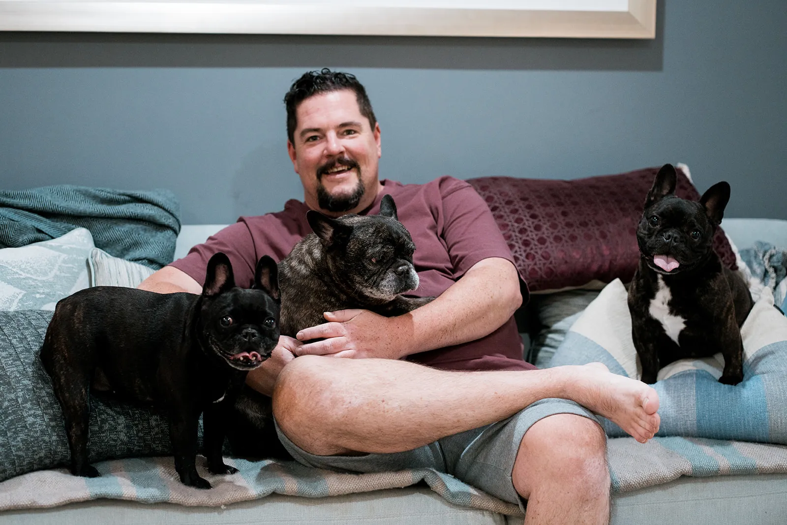 Owner relaxing at home with all three dogs