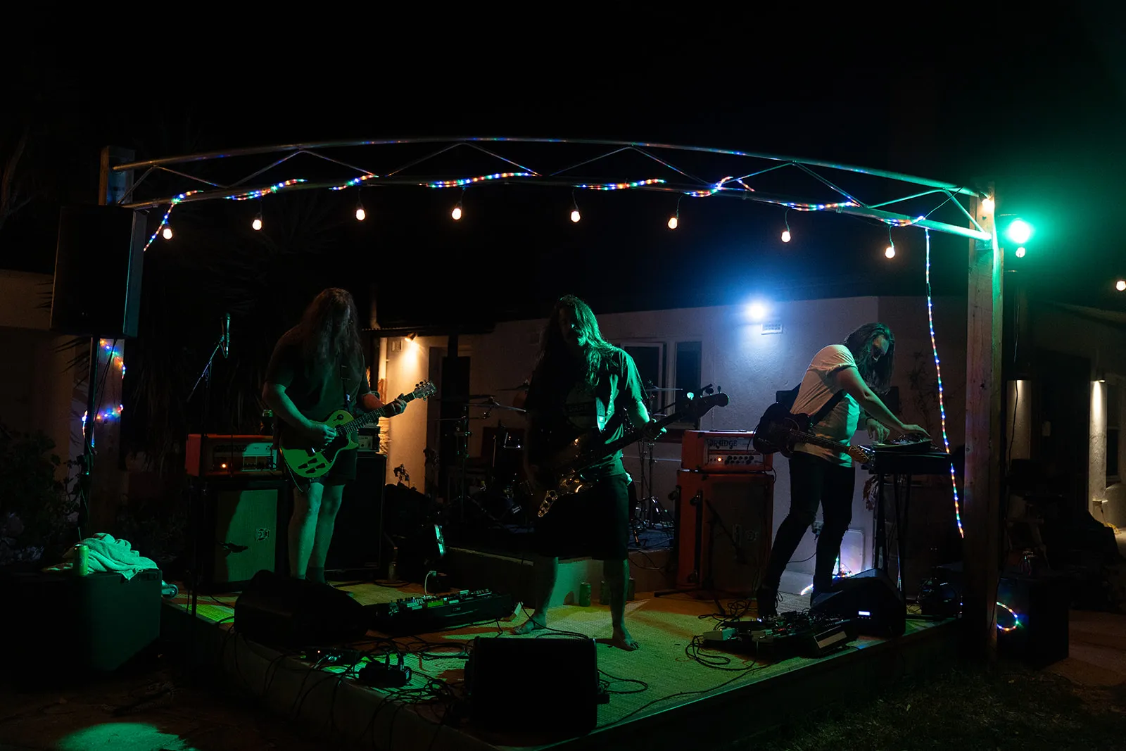 Full band on stage under the venue lights