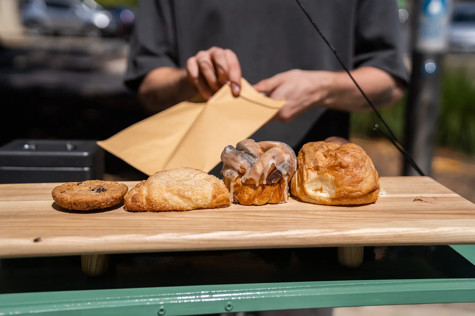 Hands serving fresh market food at the stall