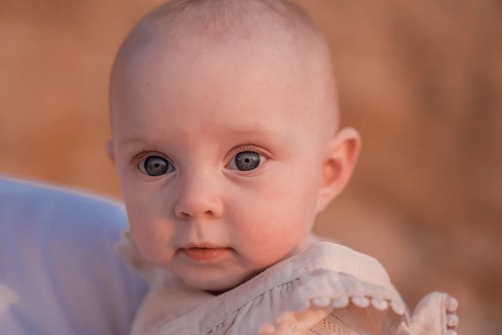 Baby portrait with direct eye contact and soft natural colour