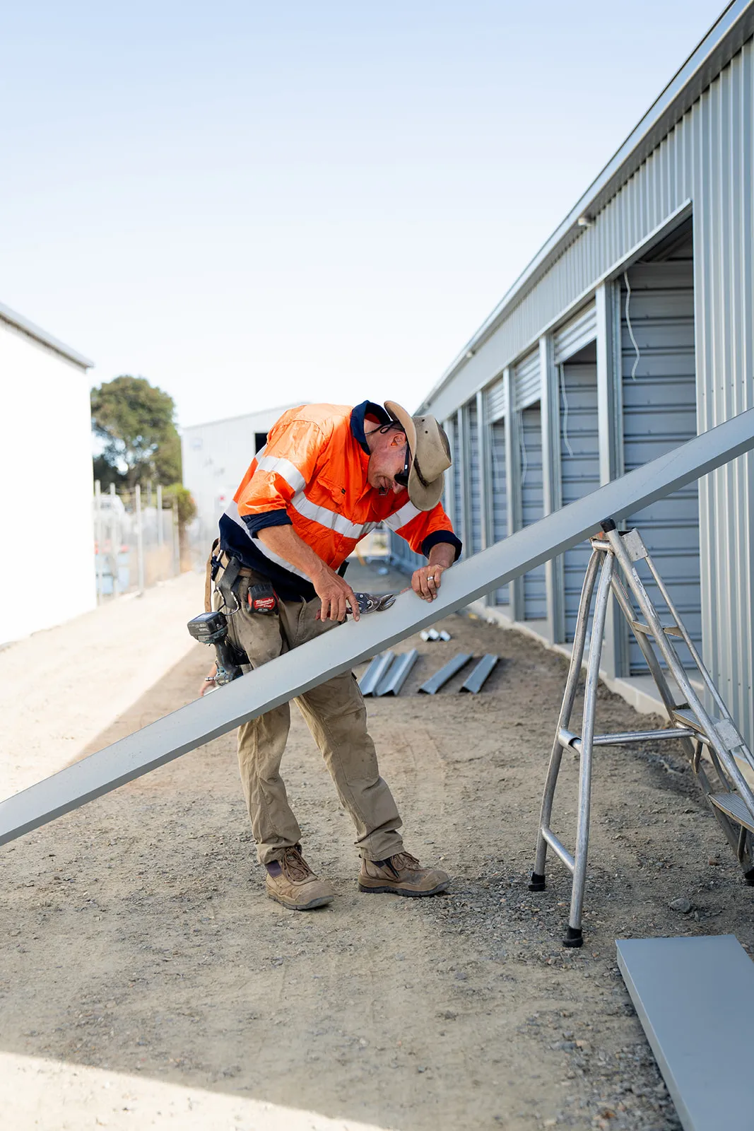 Shed builder at work on site, craft and context in one frame