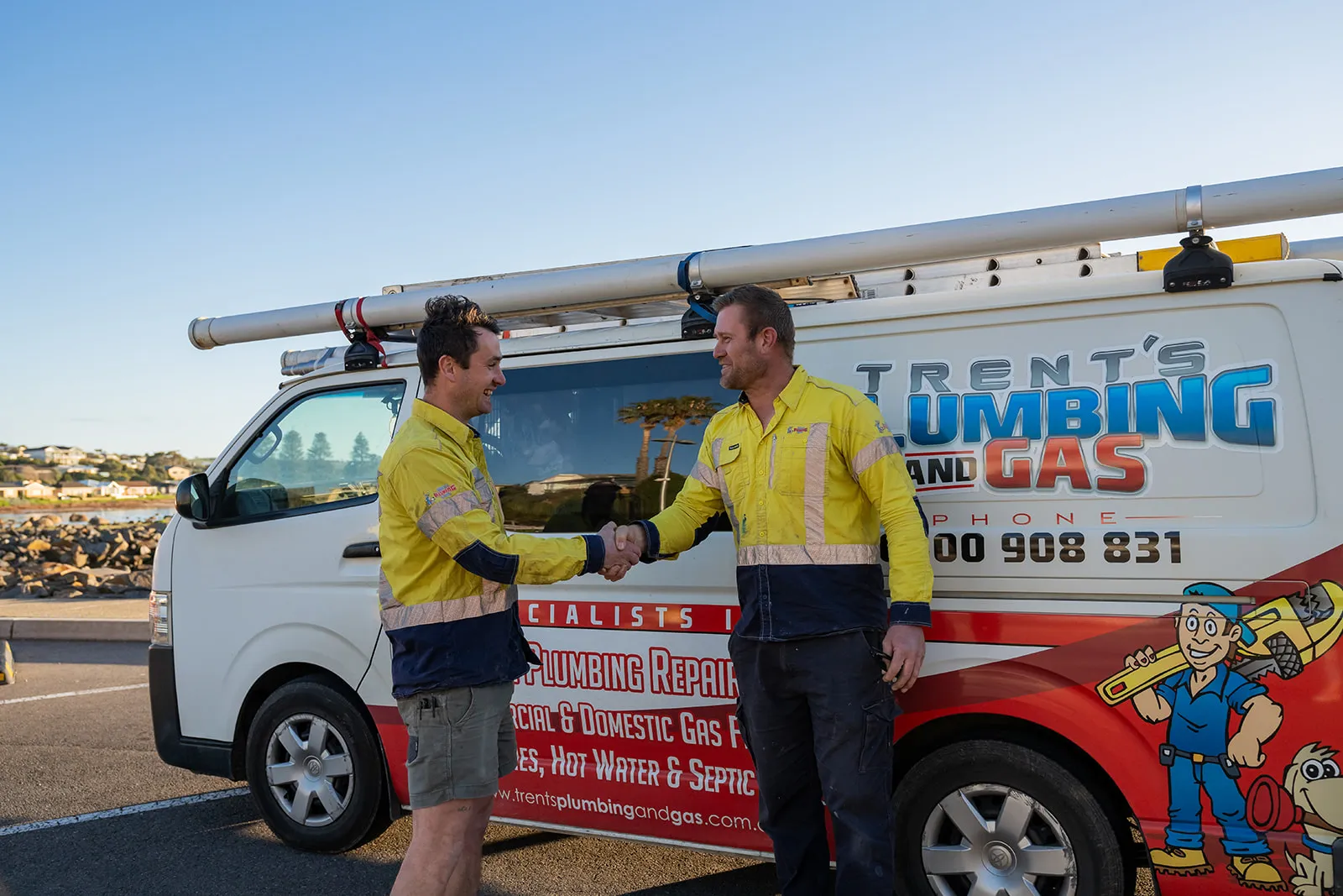 Team members chatting in front of the fully branded van