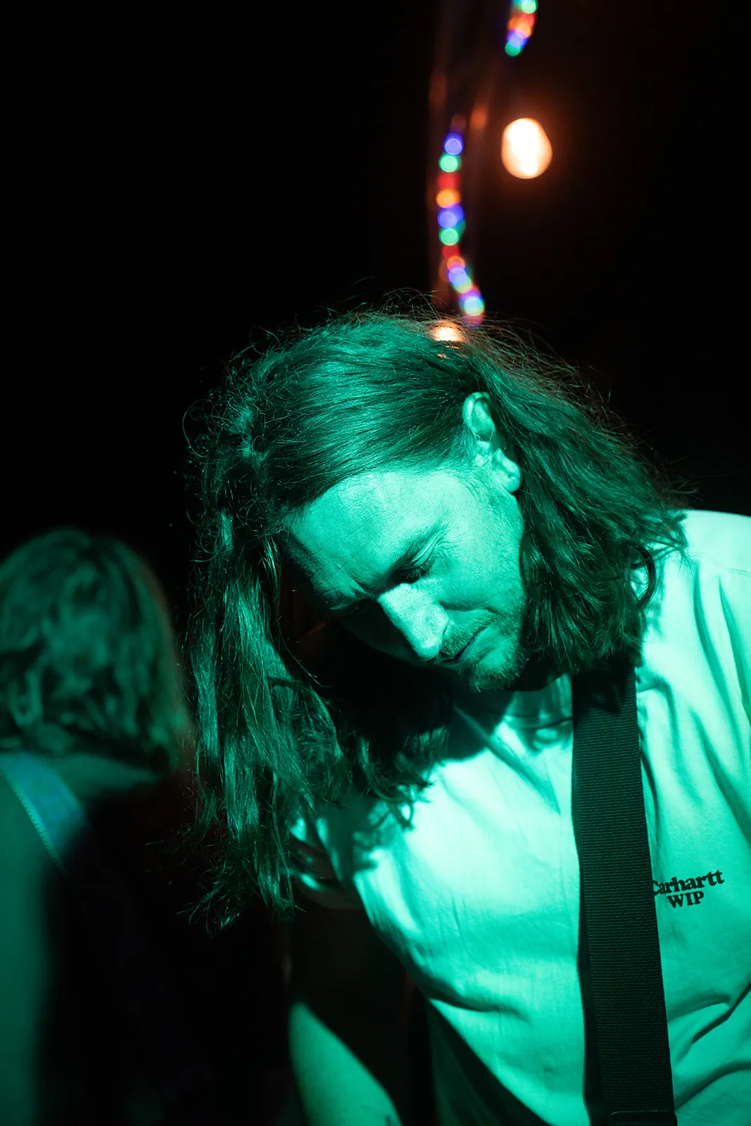 Tightly framed colour portrait of the vocalist in stage light