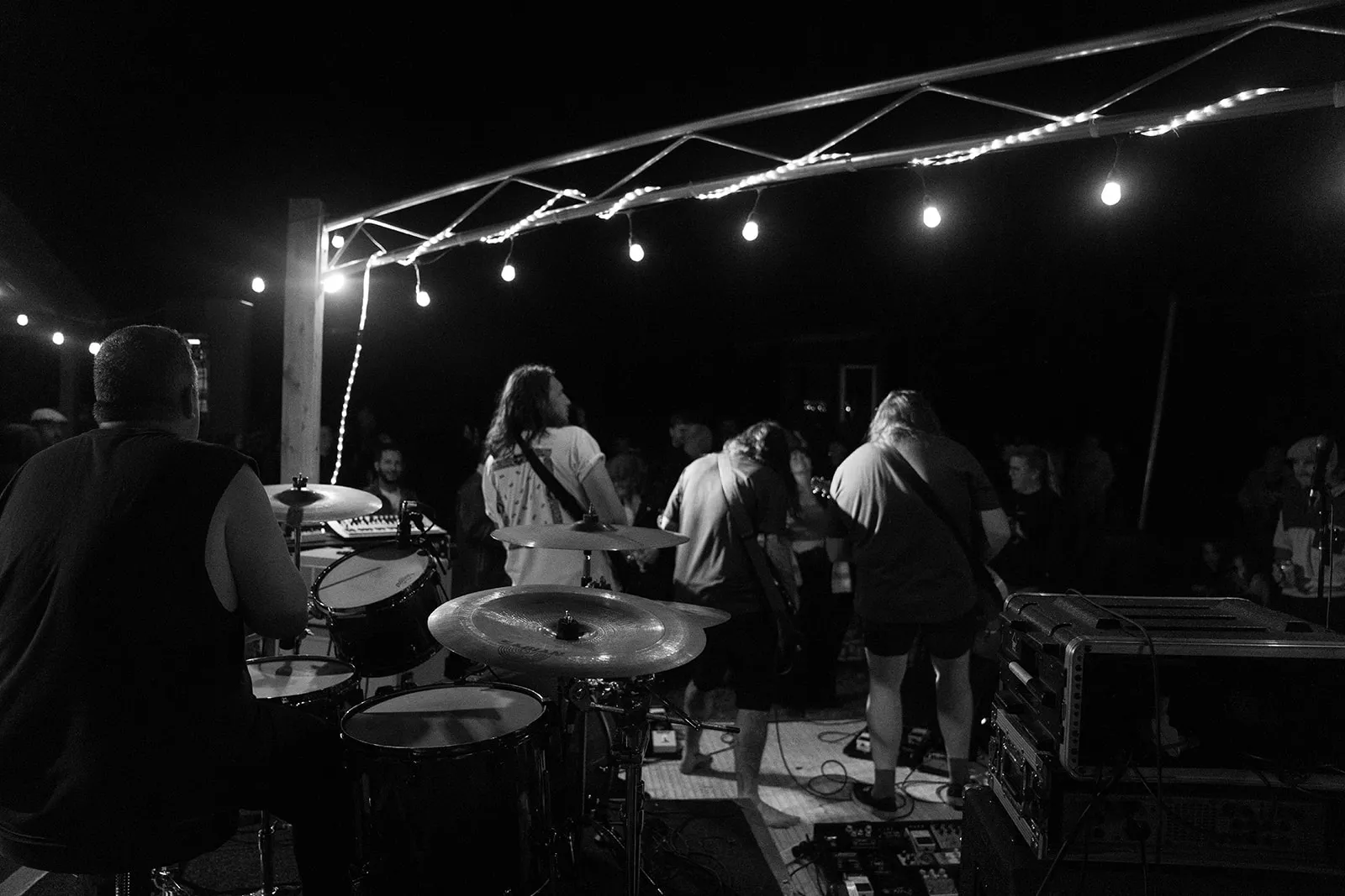 Cinematic view from behind the band looking out at the crowd