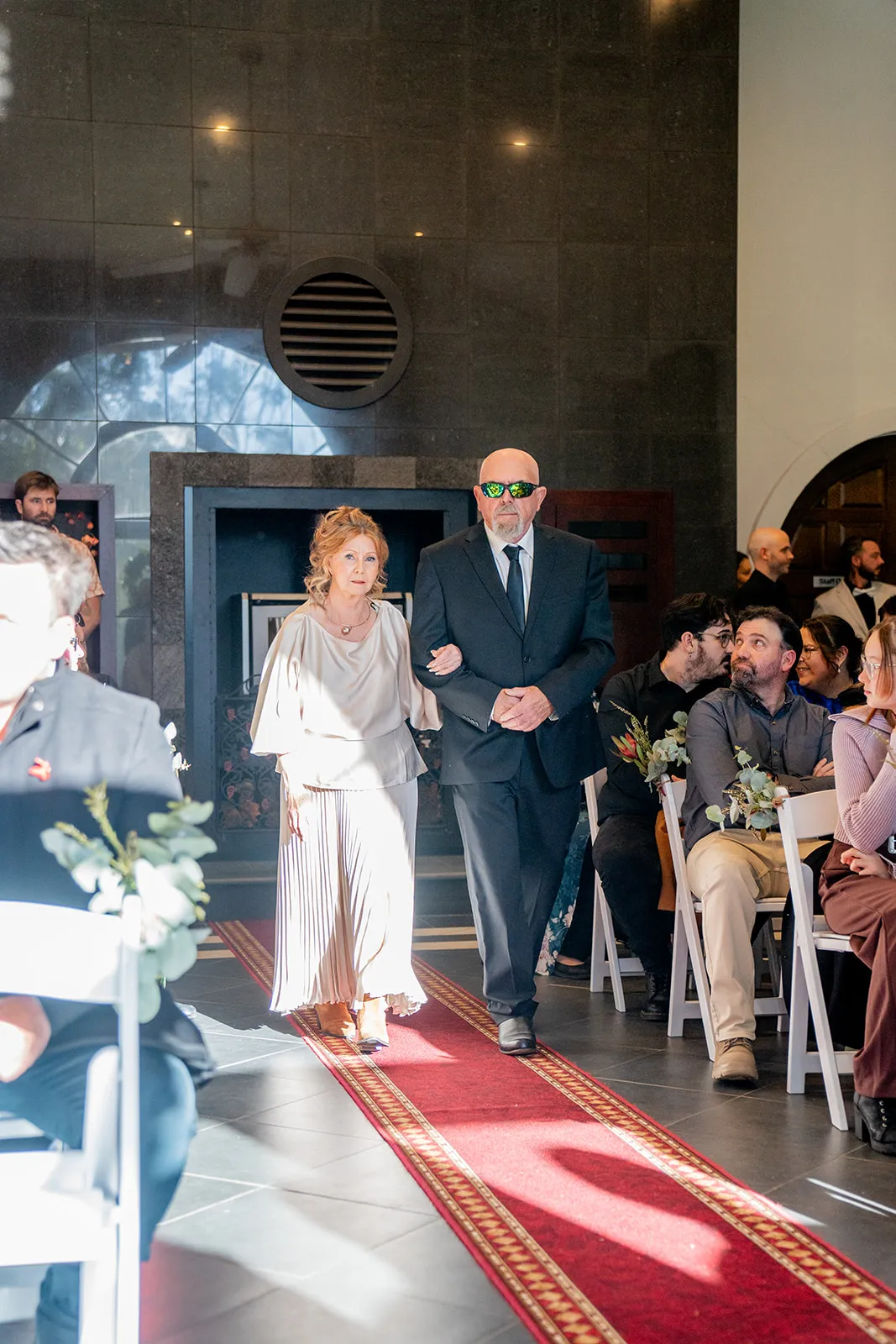 Parents walking the processional at the start of the ceremony