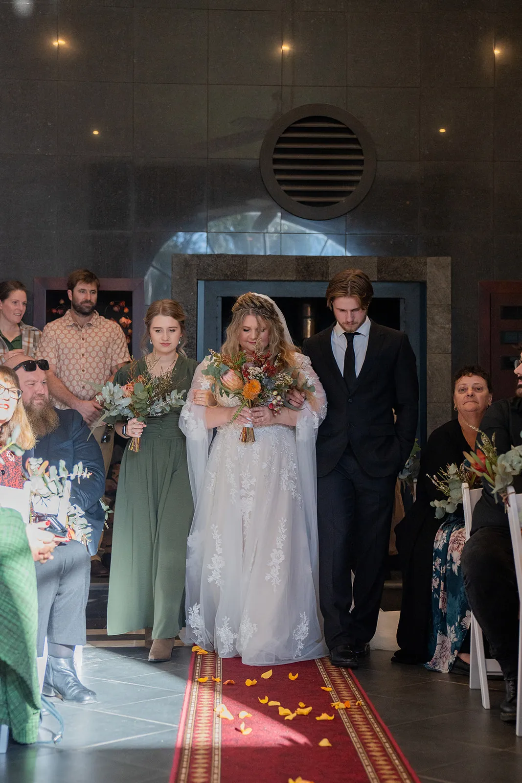 Bride entering the aisle with her family
