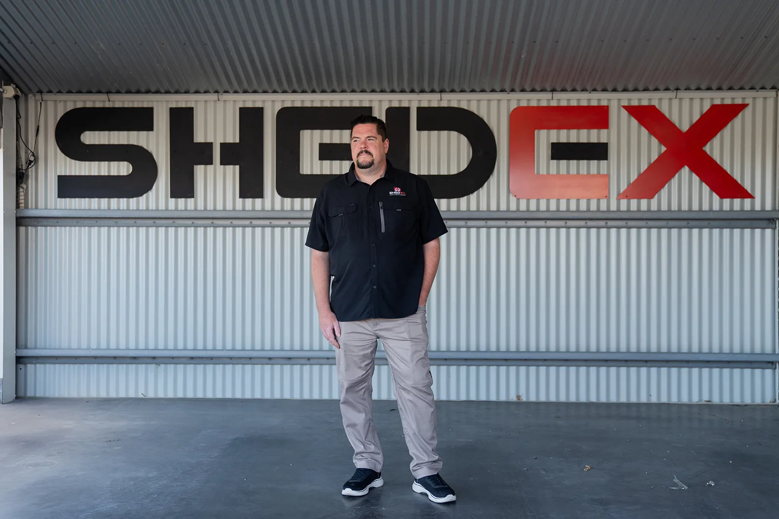 Founder portrait against oversized company branding