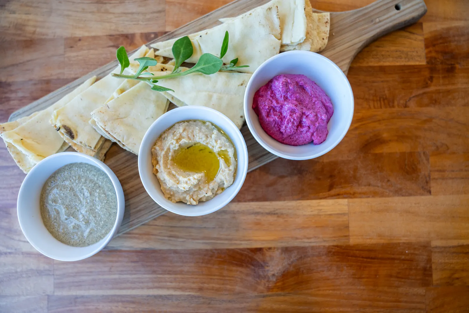 Colourful overhead composition of house-made dips
