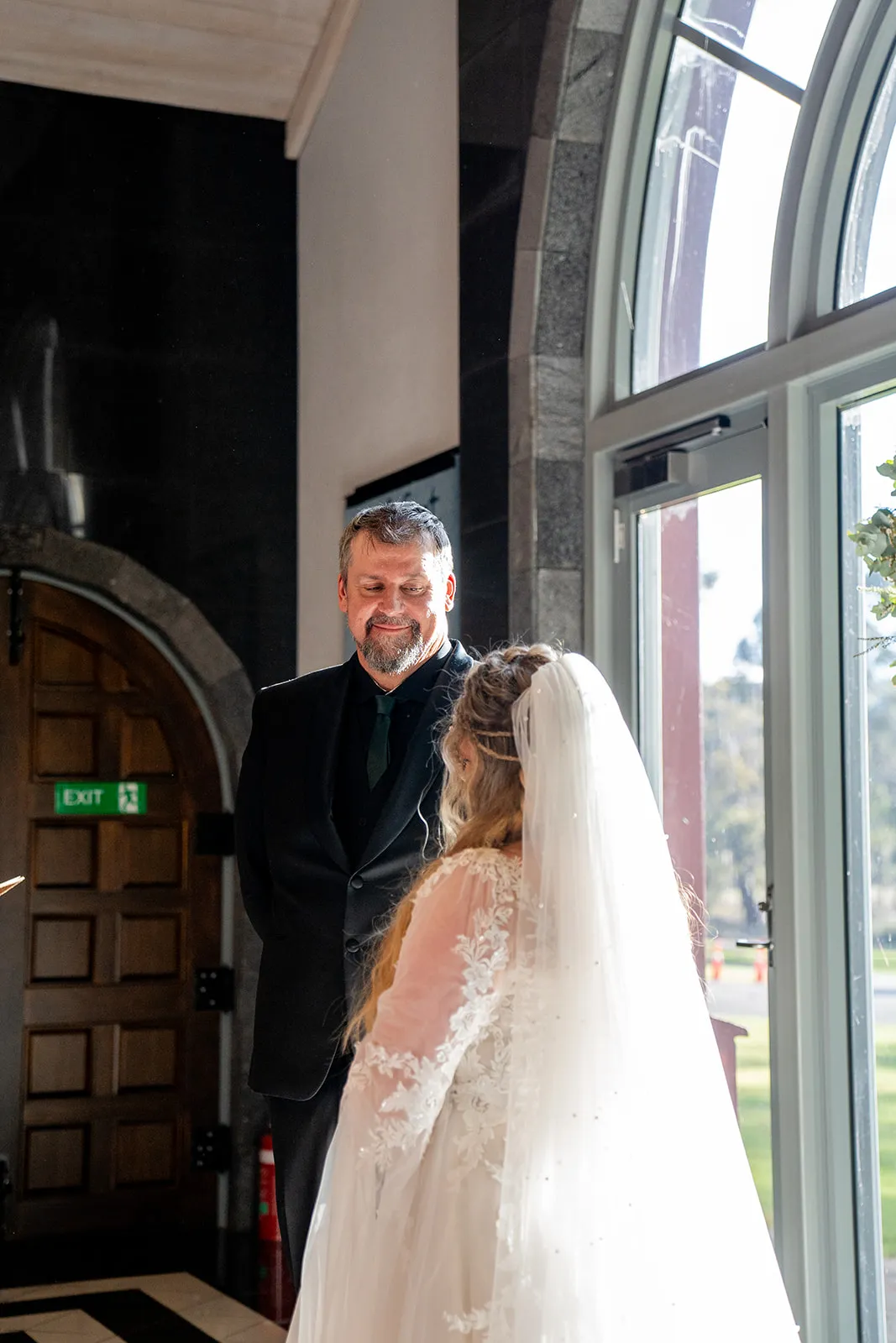 The groom's expression as he looks toward his bride