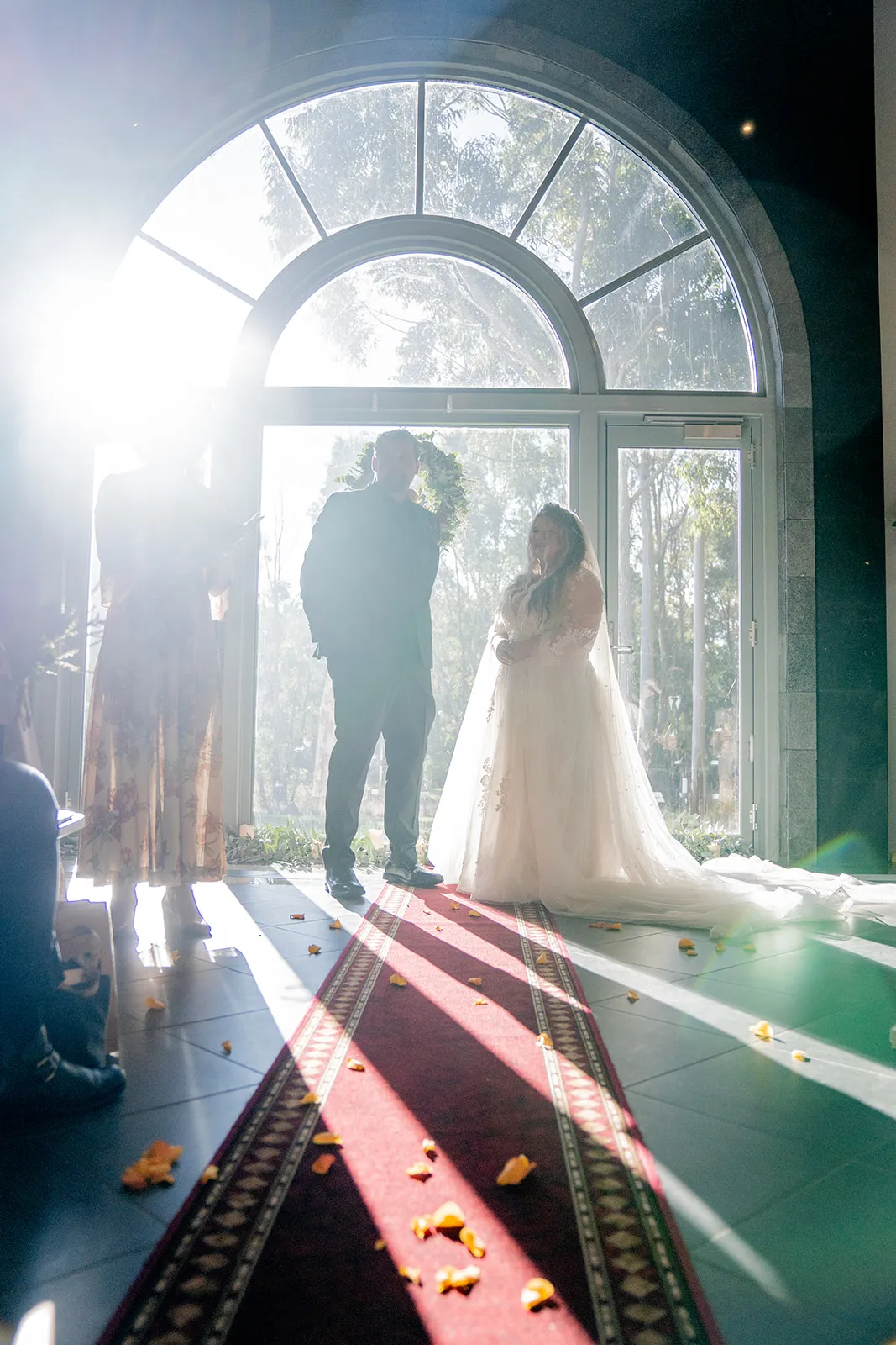 Dramatic backlit wide view of the wedding ceremony