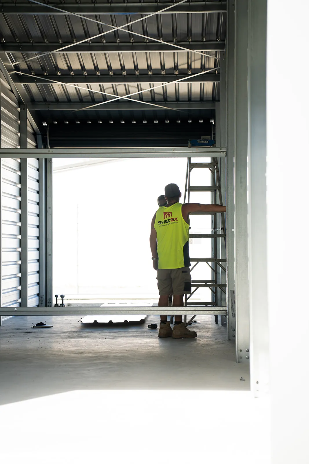 Architectural shed interior with a worker providing scale