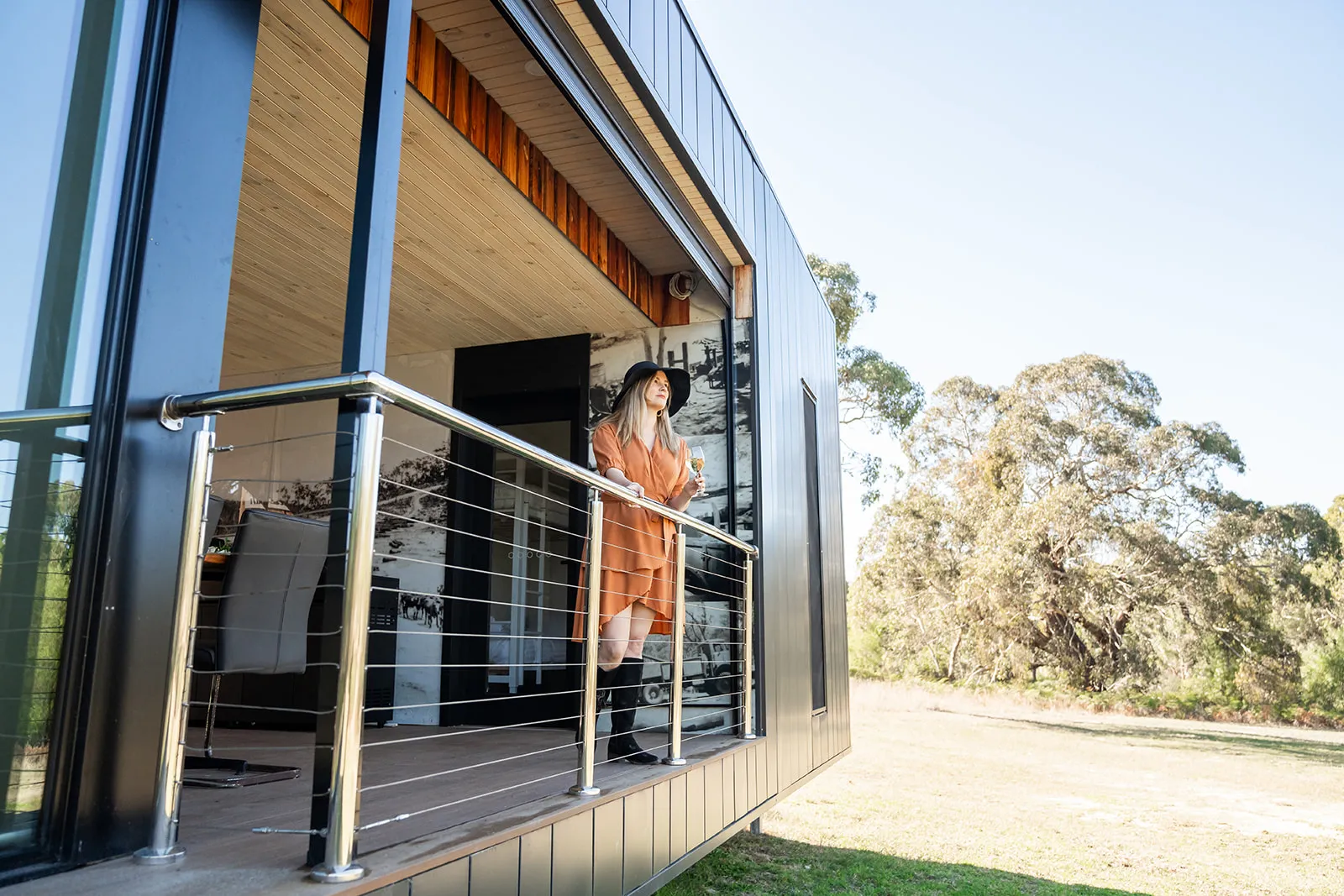 Guest relaxing against the cabin architecture