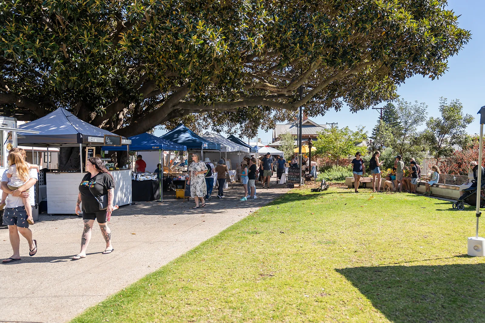 Visitors browsing the outdoor market stalls