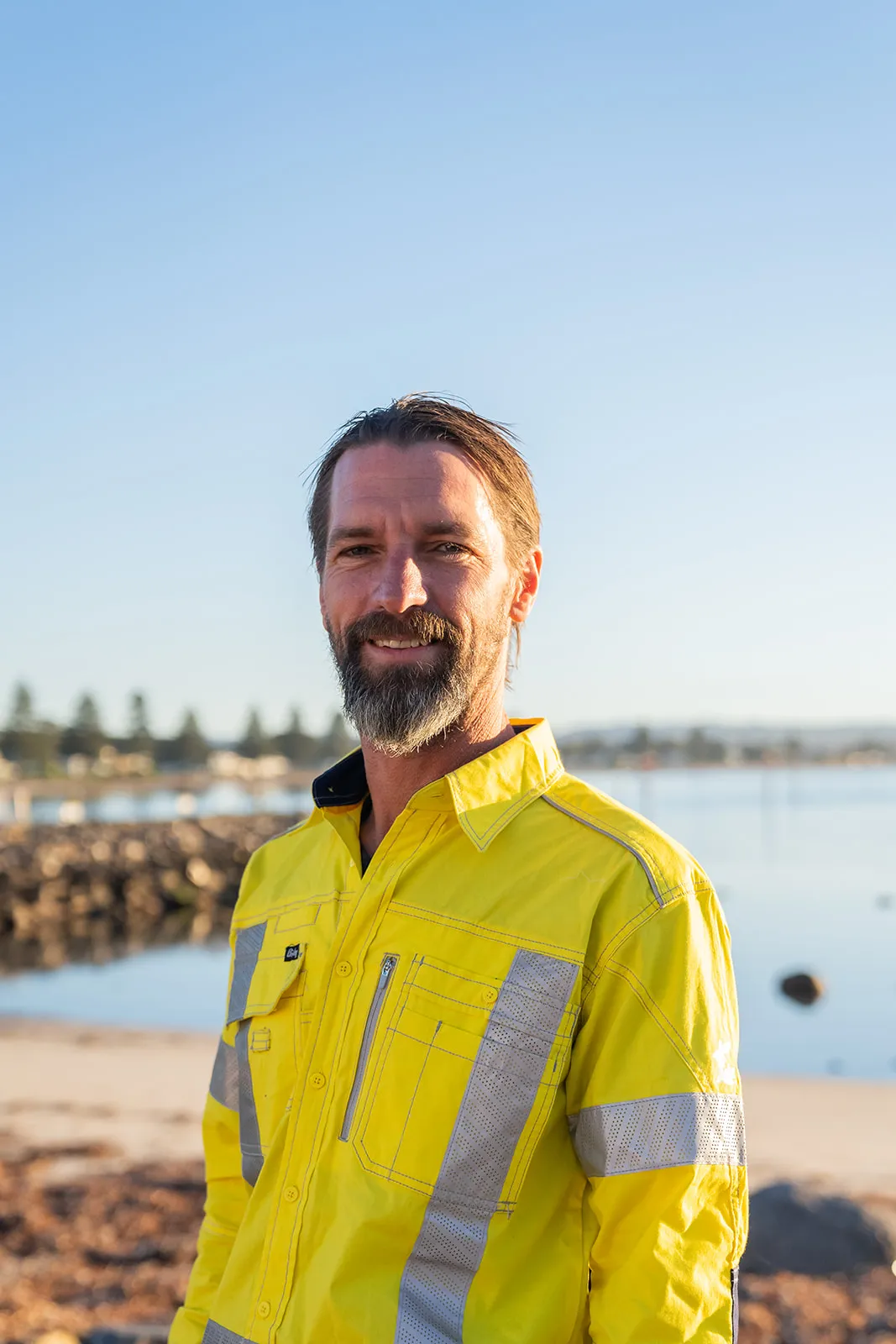 Staff portrait with a coastal backdrop