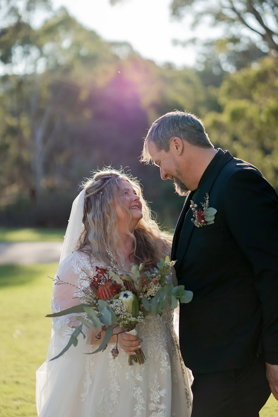 Sun-flared portrait of the couple at golden hour